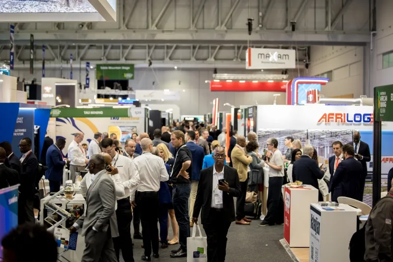 Exhibitors and attendees networking across the Mining Indaba exhibition hall