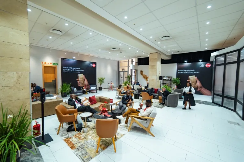 Attendees meeting in a branded sponsor lounge