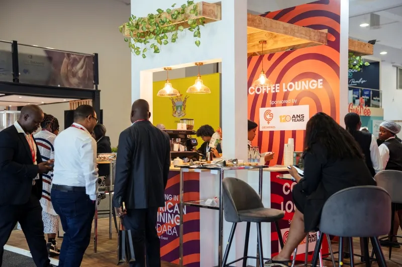 Attendees networking in a sponsored coffee lounge